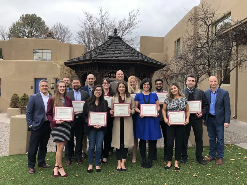 Group photo of the 2021 class with diplomas